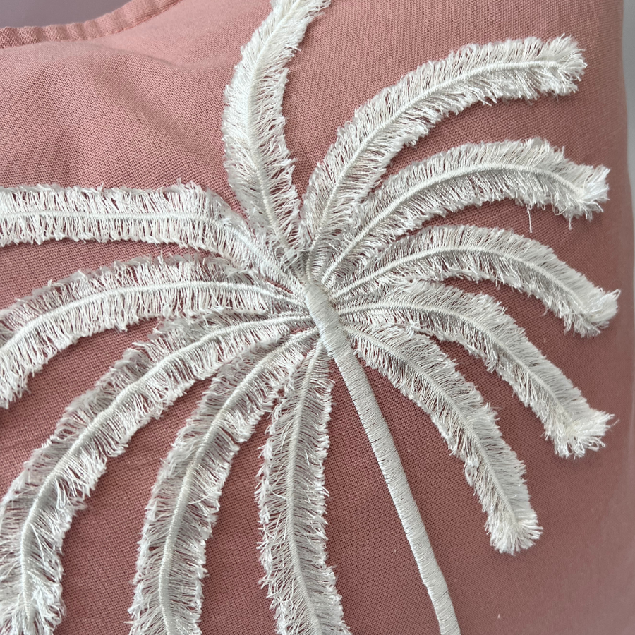 Palm tree on pink fabric.