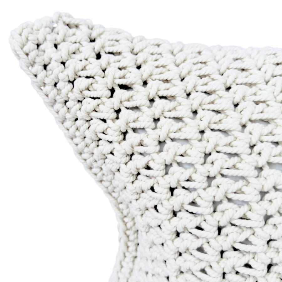 Close-up of a textured white cushion corner on a white background