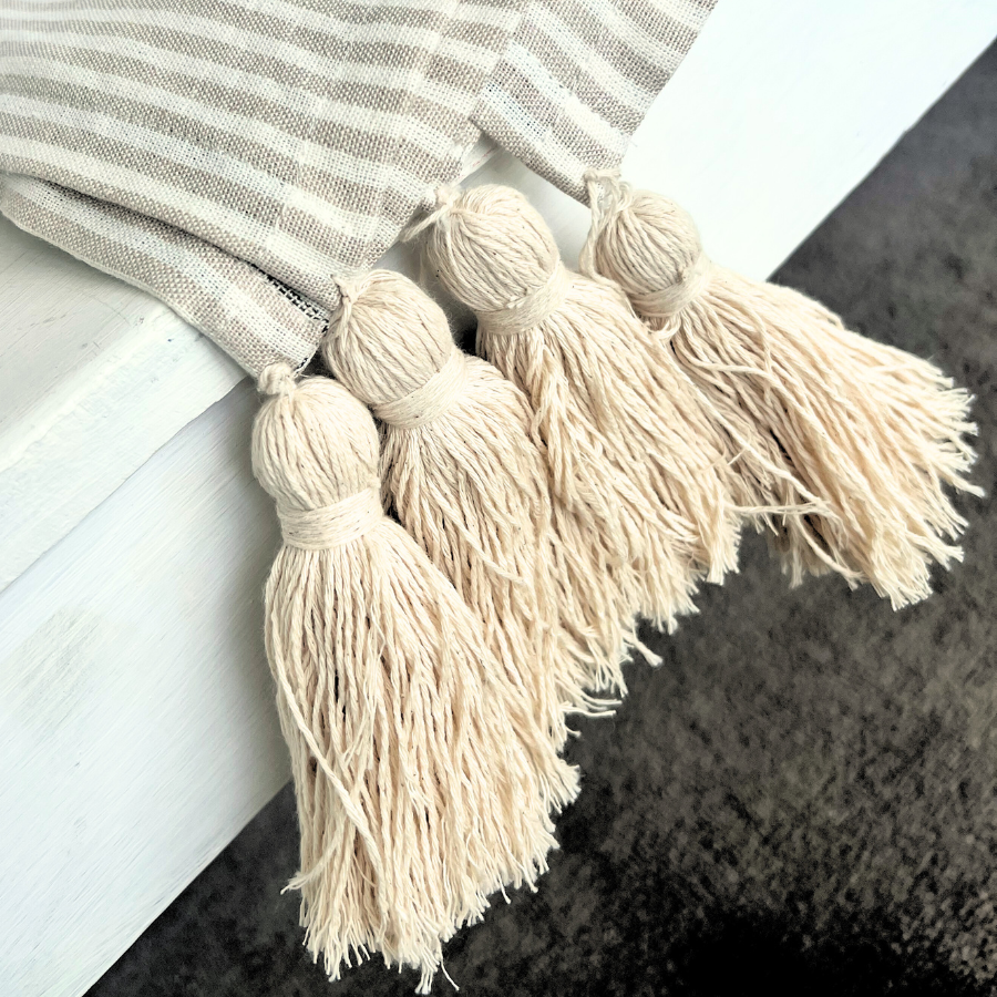 Striped blanket with tassel design.
