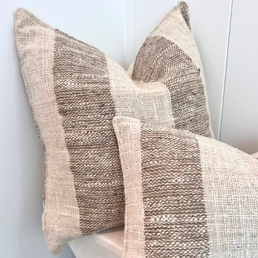 Two square throw cushion with a tweed pattern in beige and brown colors, made of cotton and linen blends, displayed on a white background.