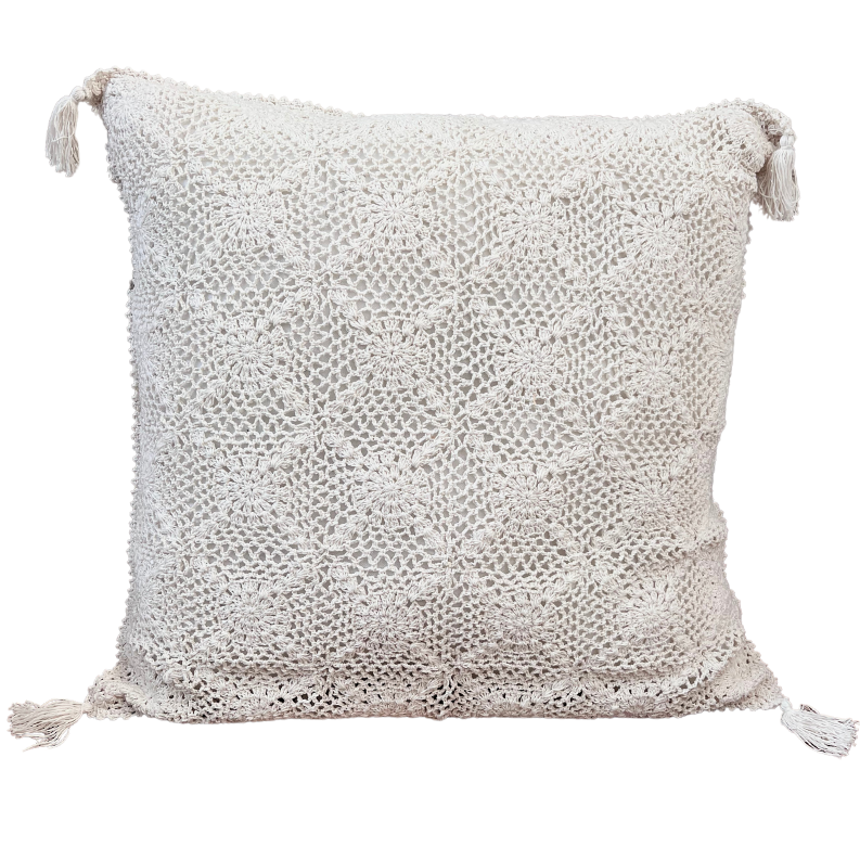 Hand crocheted beige cotton floor cushion with intricate lace-like pattern and tassels at each corner.