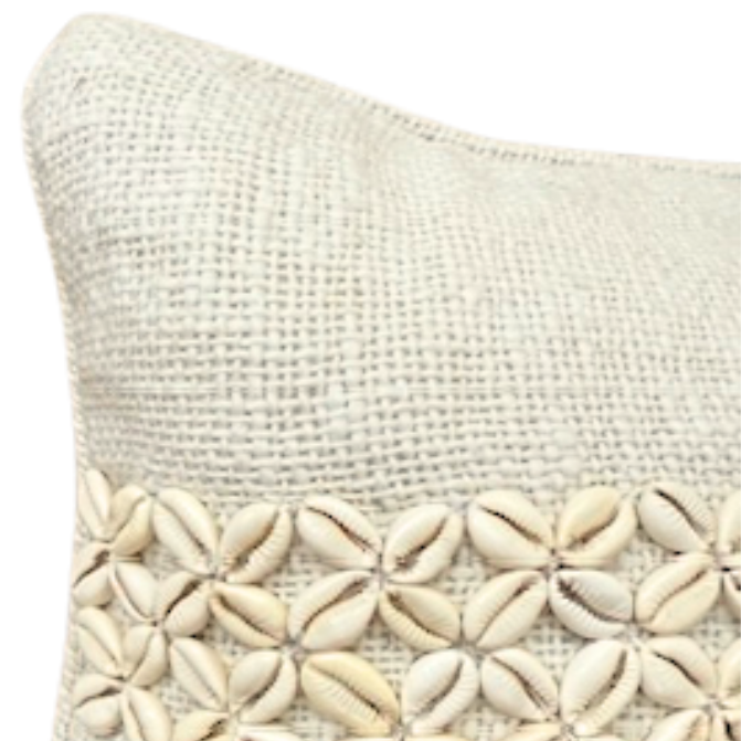 Beige cushion with shell pattern.