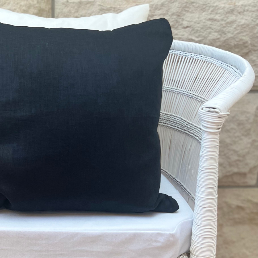 Black and white cushion on a chair.