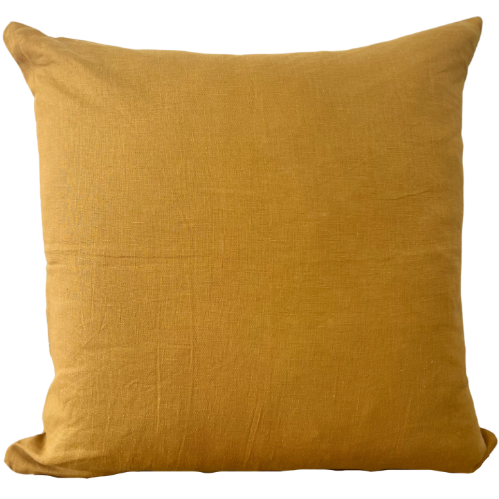 A square-shaped mustard yellow fine-linen scatter cushion with a visible textured pattern.