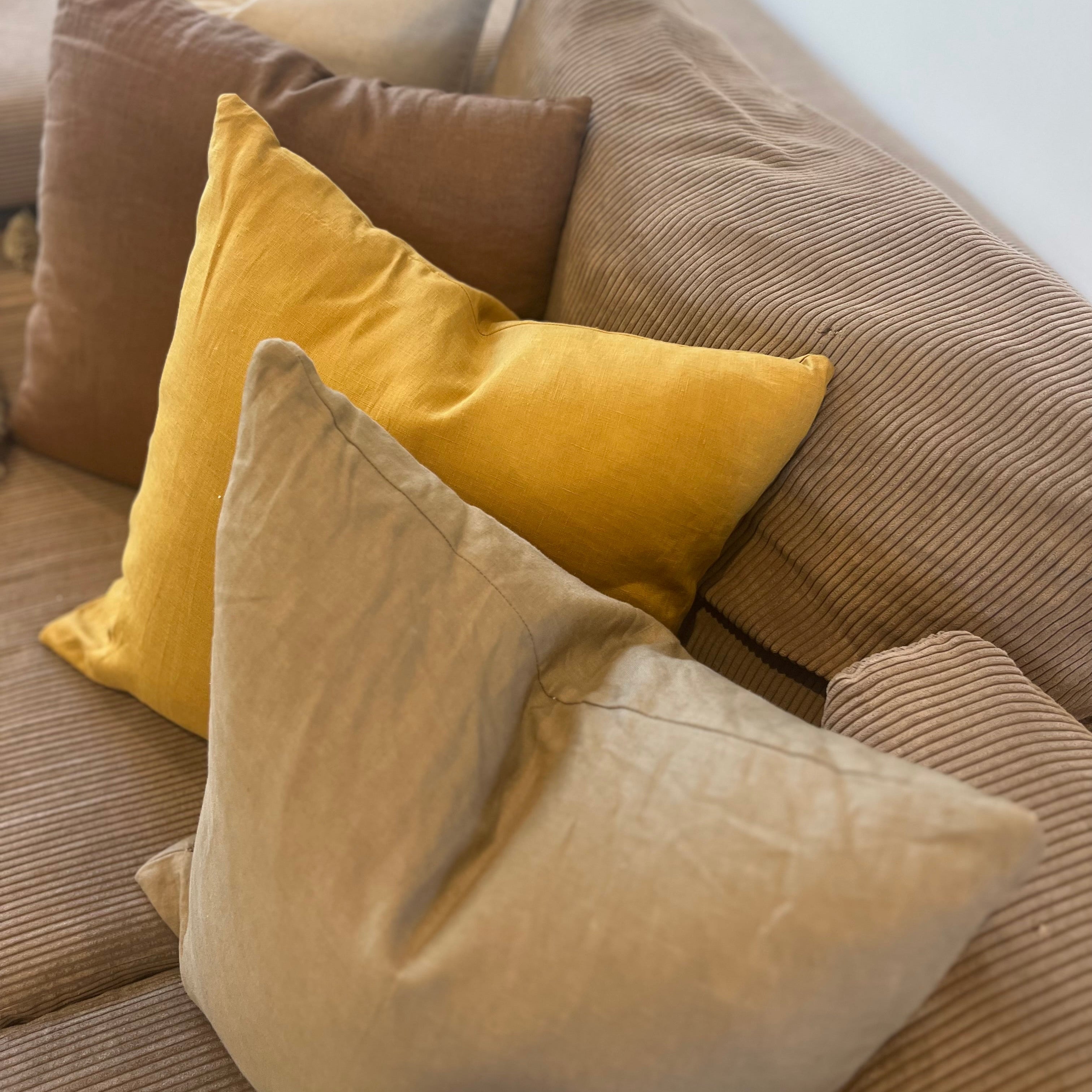 Cushions on a brown sofa.