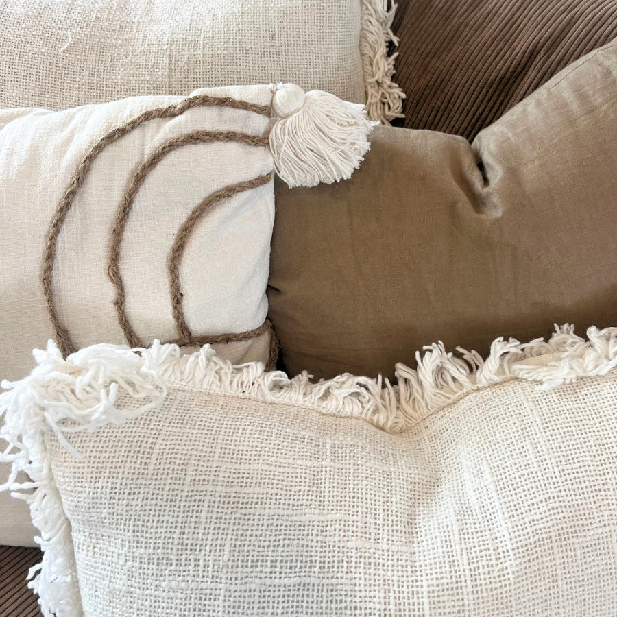 Brown and white cushions on a sofa.
