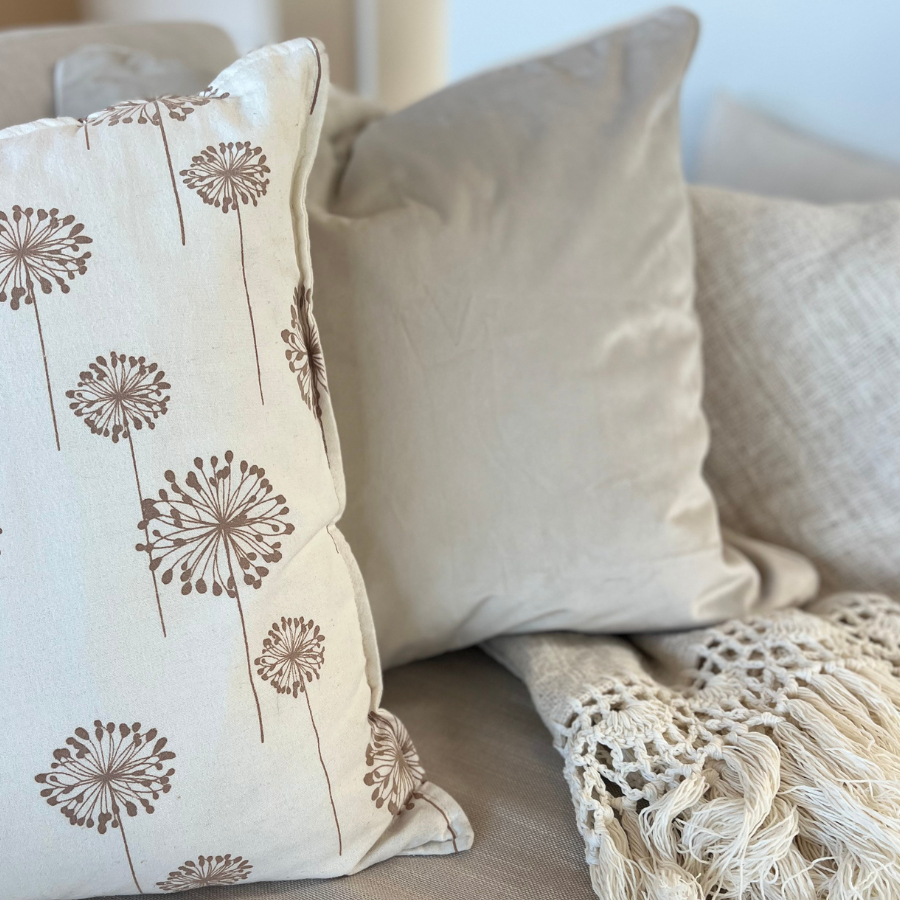 Flowered design cushions with blanket.