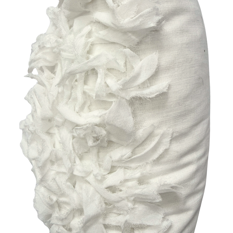 Close-up of a white cushion with textured surface.
