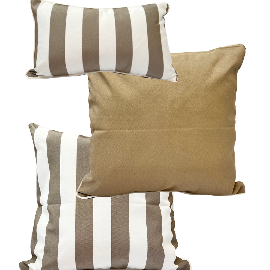 A set of three outdoor cushions in natural taupe color, with one solid color cushion and two striped cushions.