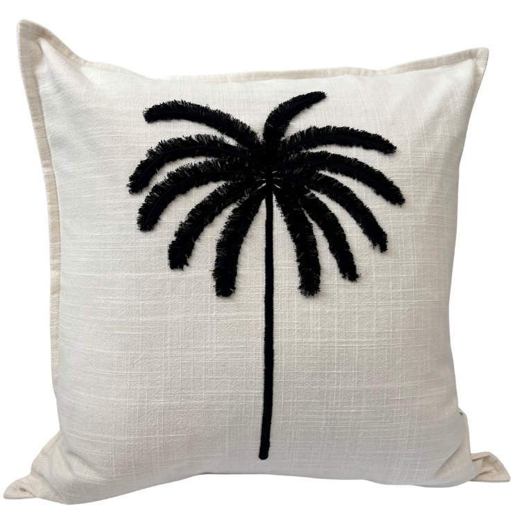 A cushion cover with a tufted embroidered palm tree on a cream background, with a contrasting black thread used for the palm fronds.