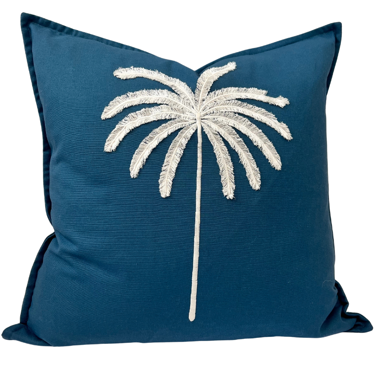 A navy blue cushion cover with an embroidered palm tree design in a contrasting color on a linen blend fabric.
