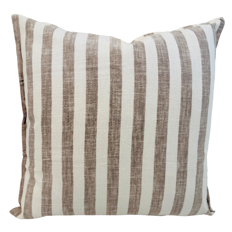 Striped cushion with brown and white stripes.