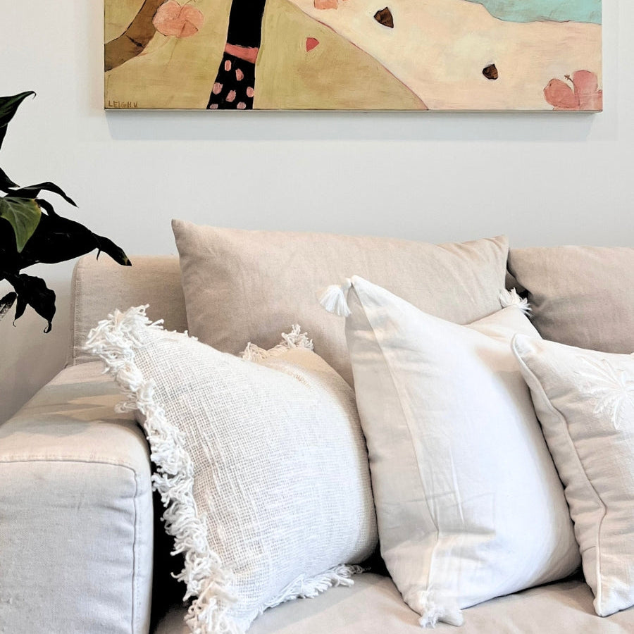 White cushions on a sofa.