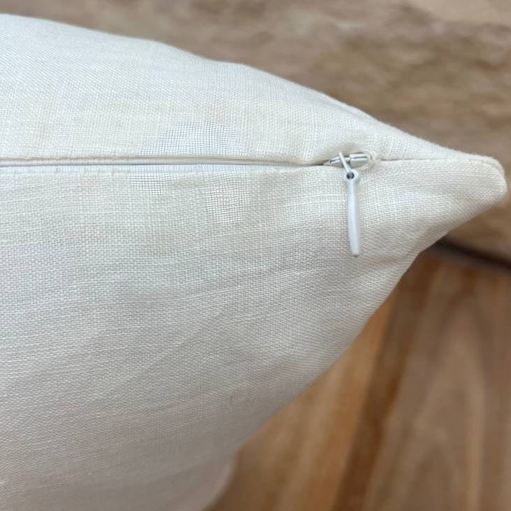 White cushion with zipper.