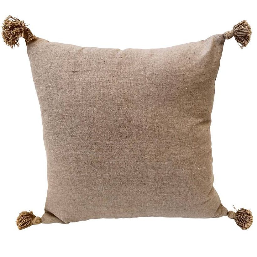 A square-shaped cushion cover in a natural ecru color with tassels on each corner.